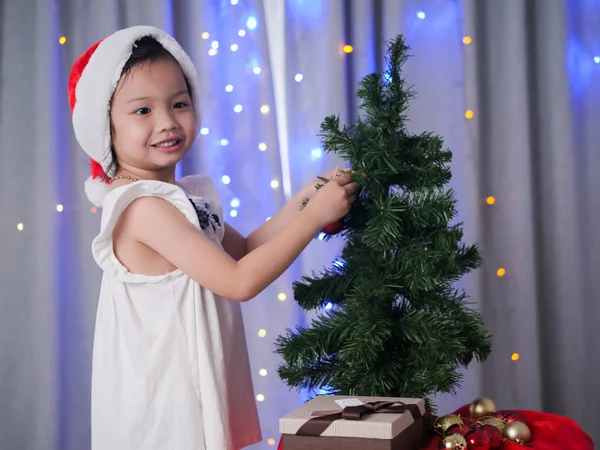 Happy Asian Girl Santa Hat Decorating Christmas Tree Home — Stock Photo, Image