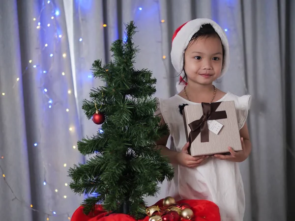 Happy Asian Girl Santa Hat Decorating Christmas Tree Home — Stock Photo, Image