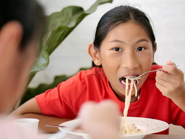 Happy Asijská Dívka Jíst Špagety Rodinou Doma — Stock fotografie