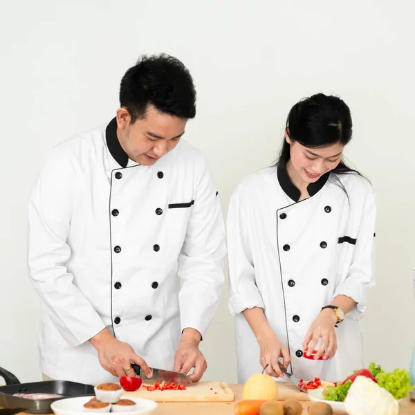 Asian chef man teaching his cook helper preparing food, work lif