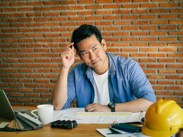 Seriously Asian architecture or engineer working in office with — Stock Photo, Image