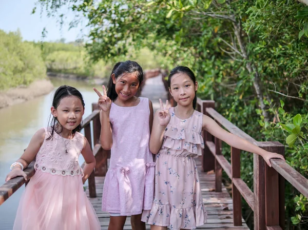 Happy girls travelling at mangrove forest in sunny day. — Stock Photo, Image