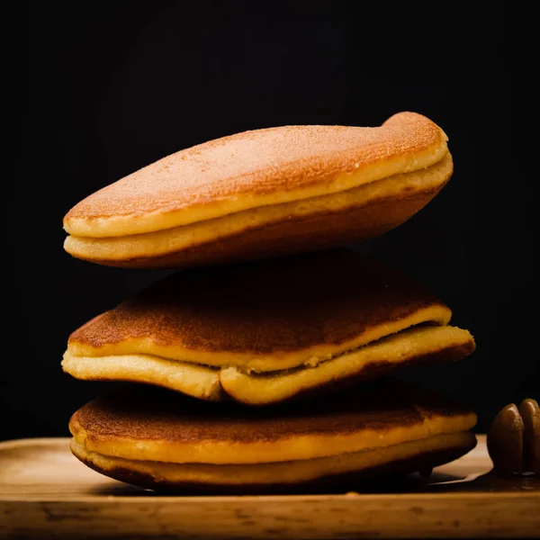 Panqueque con jarabe de miel y fondo negro . — Foto de Stock