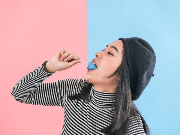 Happy Asian woman holding blue ice cream stick with color backgr — Stock Photo, Image