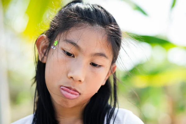 Happy Asian girl showing her tongue with snot in her nose, lifes — Stock Photo, Image