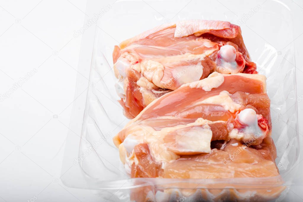 Chicken thighs in plastic pack from supermarket, ready to cook.