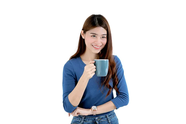 Happy Asian woman wearing blue sweater holding coffee mug in whi — Stock Photo, Image