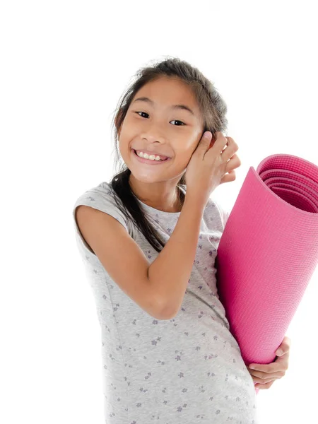 Asian girl carrying pink yoga mat on white background. — Stock Photo, Image