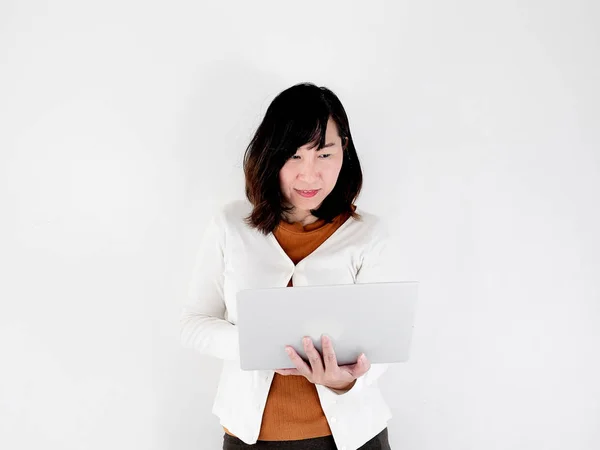 Happy Asian woman using laptop against the wall, lifestyle conce — Stock Photo, Image
