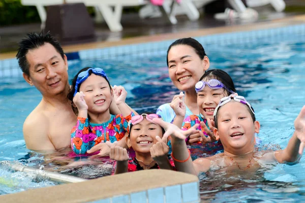 Happy Asian family enjoying in pool together, lifestyle concept. — Stock Photo, Image