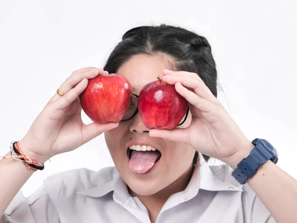 Happy schoolgirl hiding her eyes with red apple, lifestyle conce — Stock Photo, Image