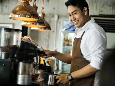Kafede, yaşam kavramı çalışan mutlu Asya barista adam.