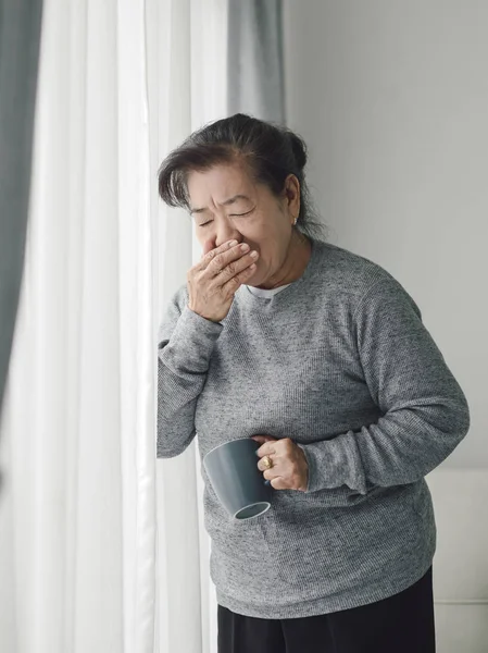 Asiática senior mujer tener un tos en casa, estilo de vida concepto . —  Fotos de Stock
