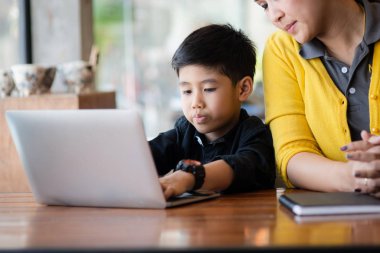 Mutlu Asya anne ve oğlu dizüstü evde kullanma.