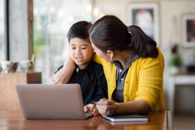 Mutlu Asya anne ve oğlu dizüstü evde kullanma.