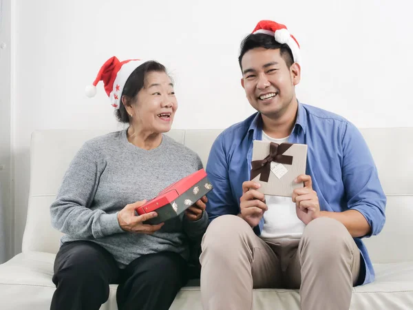 Asian mother and son holding gift box for christmas concept.