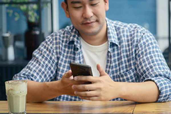 Hombre asiático inteligente usando teléfono inteligente en la cafetería, concepto de estilo de vida . — Foto de Stock