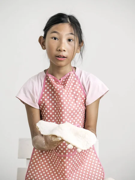 Asian girl holding dough for making bread or pizza, lifestyle co — Stock Photo, Image