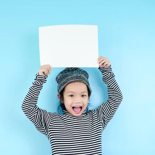 Asiatico ragazza in inverno costume holding bianco carta bianca su blu b — Foto Stock