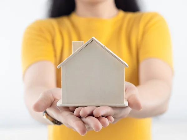 Asian woman holding house in her hands real estate concept. — Stockfoto