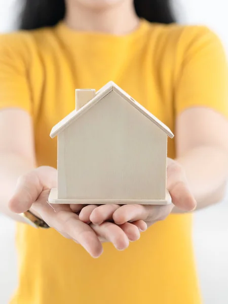 Asian woman holding house in her hands real estate concept. — ストック写真