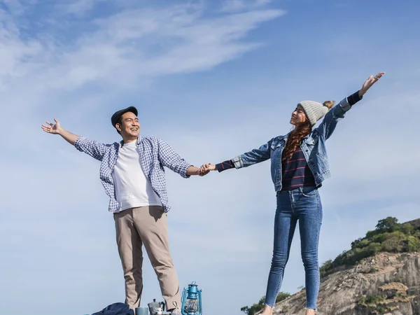 Feliz ásia casal levantando mãos em conjunto com natureza fundo — Fotografia de Stock