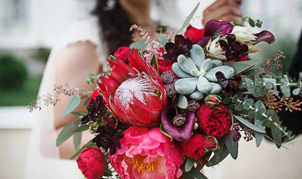 Wedding bouquet of the bride. Floristics, festive decoration of fresh flowers of the ceremony. Symbol of love, roses in pastel shades, succulents in decorative elements, wildflowers. Space for text