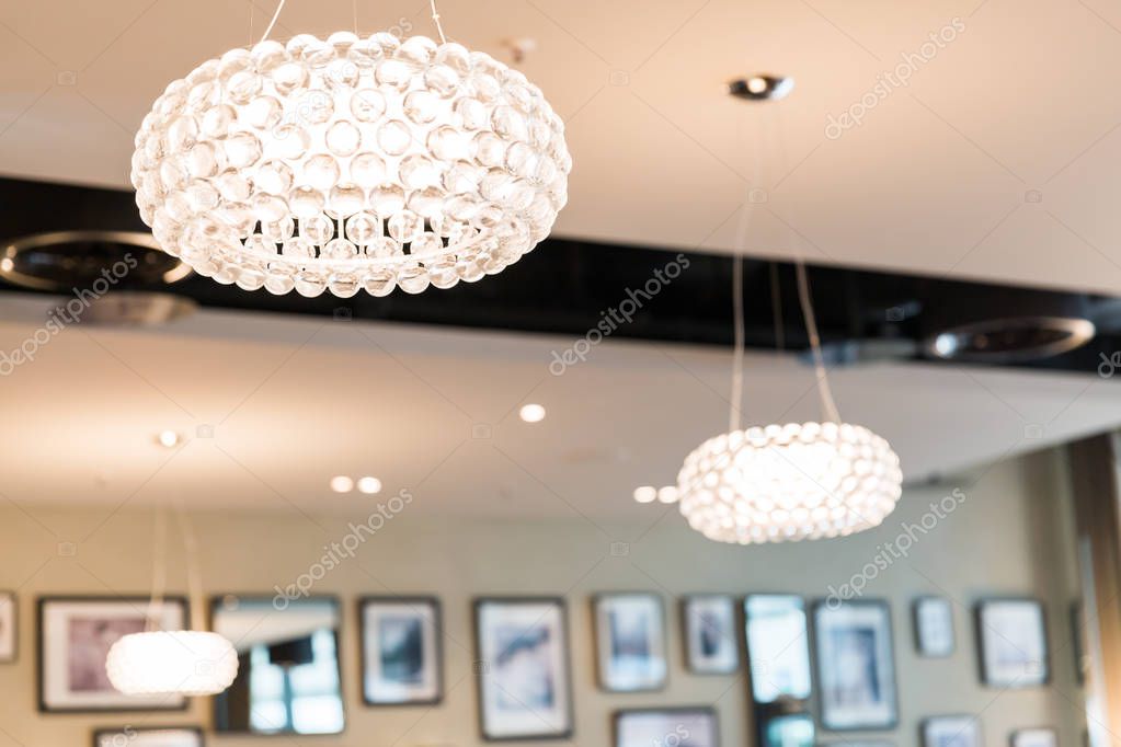 Brightly Lit Round Ceiling Lighting in Restaurant with Blurred Background