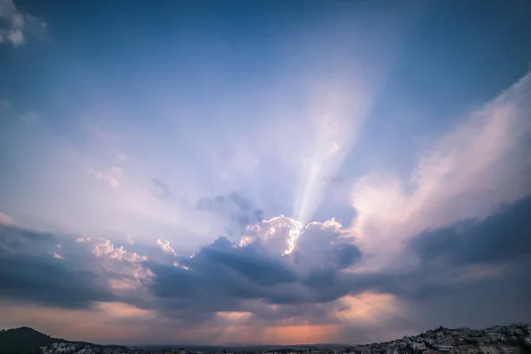 Heavenly Light Rays Piercing Through the Clouds over the Greek Sea