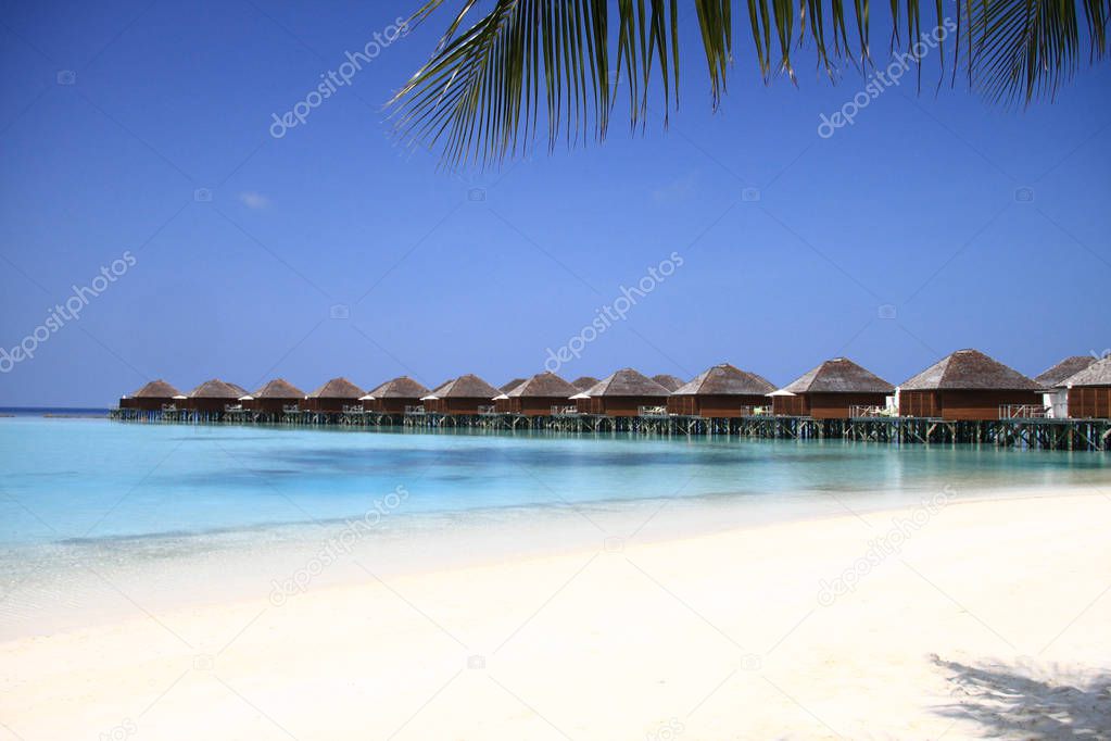 Maldives Island Resort Beach and Overwater Bungalows on Pacific Ocean