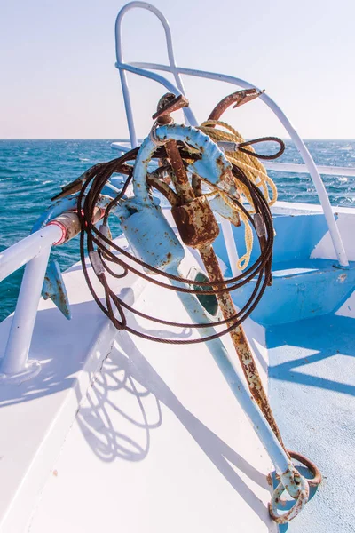 Rusty Anchors on Dive Boat Deck in the Sun with Sea in the Background