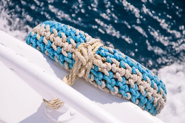 Car Tyre Recycled as Boat Fender with Sea in the Background