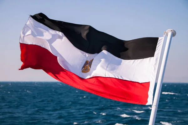 Egyptian Flag Floating in the Sun with Red Sea in the Background