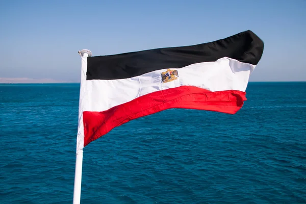 Egyptian Flag Floating in the Sun with Red Sea in the Background