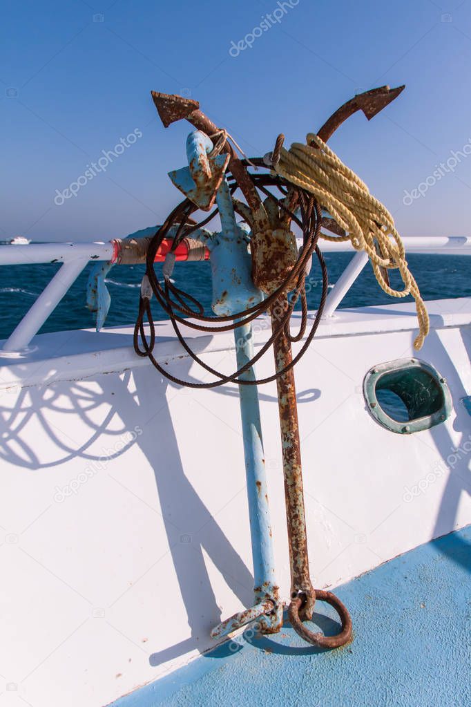 Rusty Anchors on Dive Boat Deck in the Sun with Sea in the Background