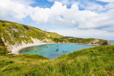 Boats Mooring in Lulworth Cove and Atlantic Ocean clipart