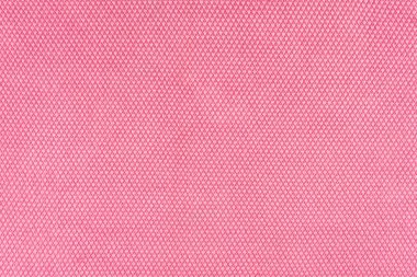 Gerçek, pembe örme kumaş parçası hassas deseni ile sentetik elyaflar dokulu arka plan yapılmış.
