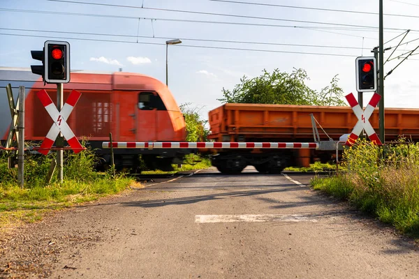 Closed Barrier Railway Crossing Red Warning Lights Blurred Locomotive Motion — ストック写真