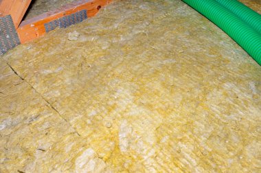 Ceiling and attic floor insulation made of rock wool between the trusses.
