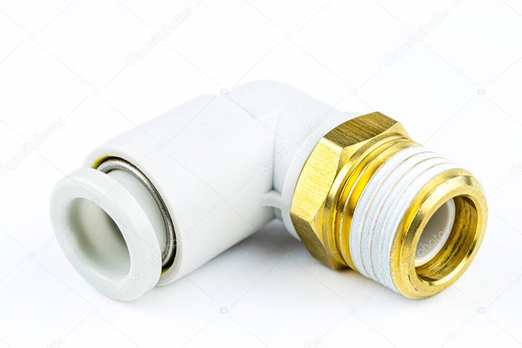 Macro shot of a white, pneumatic elbow fitting for a plastic tube with a 1/2 inch brass external thread, isolated on a white background with a clipping path.