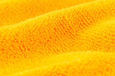 Turuncu mikrofiber kumaştan yapılmış arka plan, seçici odak.