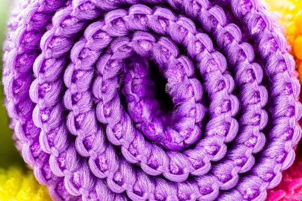 Background made of purple curled microfiber material, front view, macro shot.