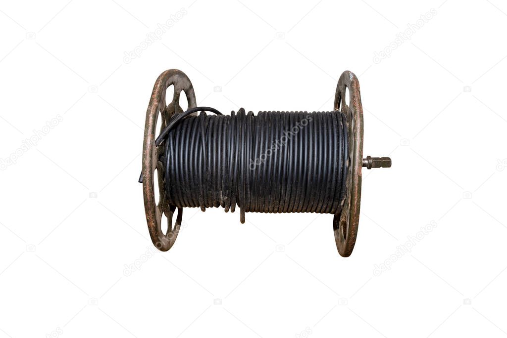 A black electric cable wound on an old metal spool, isolated on a white background with a clipping path.