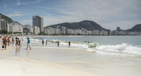 Ciudadanos nadando en el océano y caminando por la playa de Copacabana — Foto de Stock