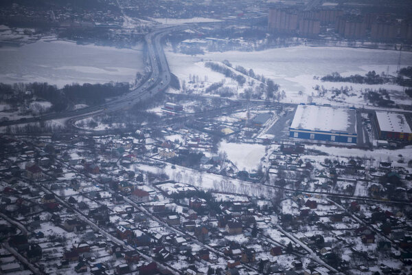 Moscow; Russia- March 08; 2019: View of the snow-covered suburbs of Moscow from an airplane
