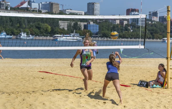 Leuke meiden spelen beachvolleybal. Vrienden kijken naar het spel. — Stockfoto