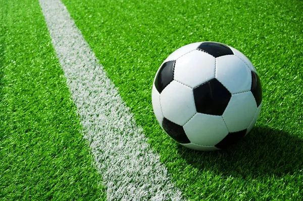 futbol topu siyah ve beyaz çizgili yeşil çimenlerin üzerinde