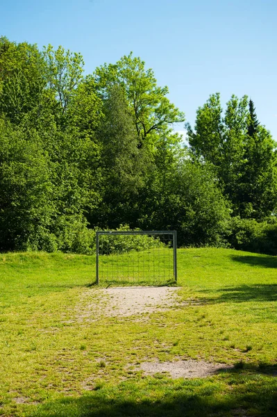 Football ground, soccer field with chain goals in the nature