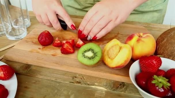 Billetera para cóctel de frutas en una tabla de cortar plátanos, fresas, melocotón . — Vídeos de Stock