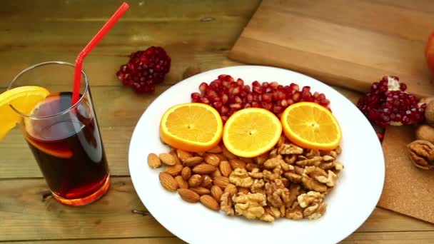 Ένα Ξύλινο Τραπέζι Πιάτα Είναι Ρόδι Καρύδια Πορτοκάλια Αμύγδαλα Rambutan — Αρχείο Βίντεο